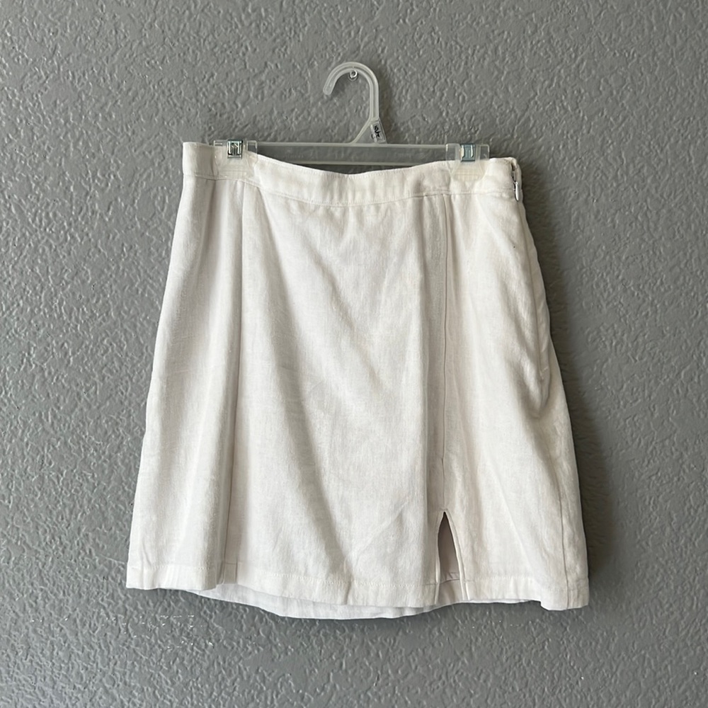 White skirt with zipper on the side. Has a slip underneath so not see through.